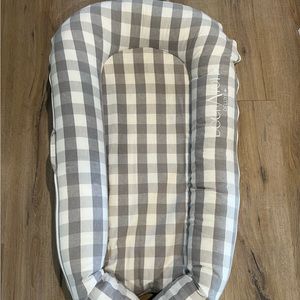 Dockatot with grey/white plaid cover
